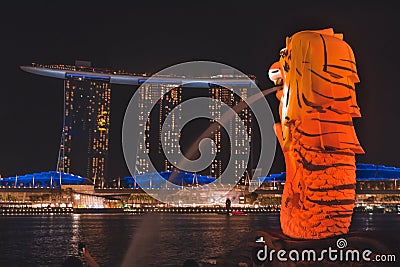 The Merlion with tiger stripes overlooking Marina Bay Sands during Singapore iLight 2019 Editorial Stock Photo